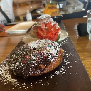 Bakers board. (Chocolate glazed donut, cinnamon bun, biscuit and pork stuffed cheddar and bacon biscuit)