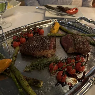 Wagyu steak, tomatoes, peppers filled with chimichurri sauce and asparagus.  This steak was cooked over wood flame.