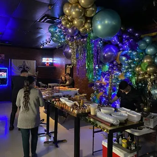people standing in front of a table of food