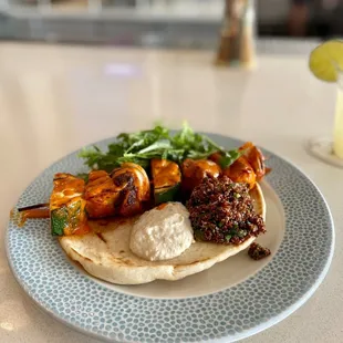 Grilled Vegetable Skewer with harissa-marinated vegetables, cucumber yogurt, quinoa salad and a tomato lemon vinaigrette!