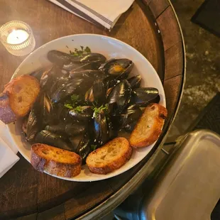 a bowl of mussels and bread