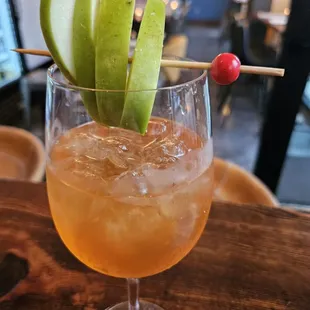 a drink with apple garnish