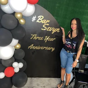 a woman standing in front of a sign