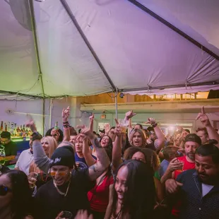 a large group of people in a tent