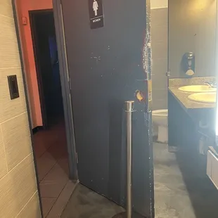 Woman's bathroom propped open