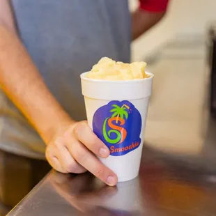 a person holding a cup of ice cream