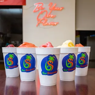 three cups of different flavored drinks