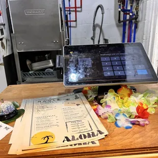 a laptop and menus on a table