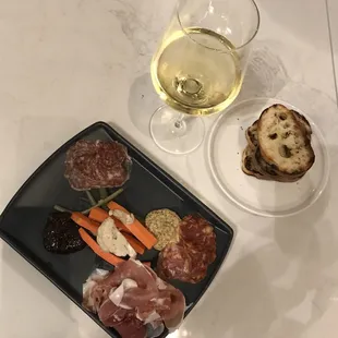 Charcuterie plate with assorted meats and pickled vegetables