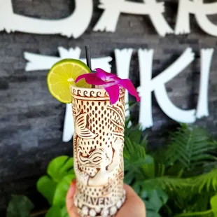 a hand holding a tiki