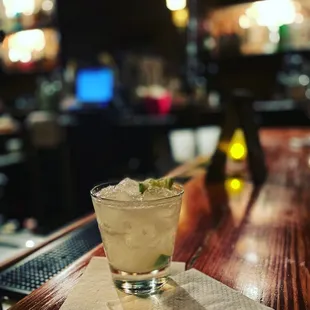 a cocktail on a wooden bar