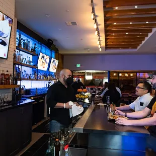 two men sitting at the bar
