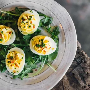 a plate of deviled eggs on a wooden table