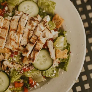 a salad with chicken and cucumbers
