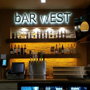 a bar with a lot of bottles on the shelves