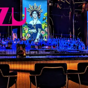 a stage with chairs and a bar sign