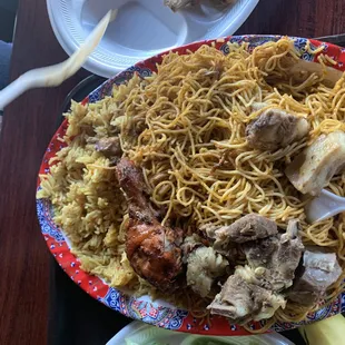 a plate of noodles with meat and vegetables