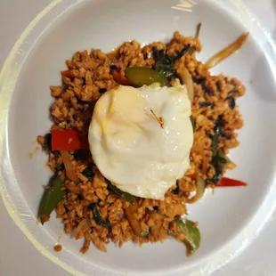 a fried egg on top of rice