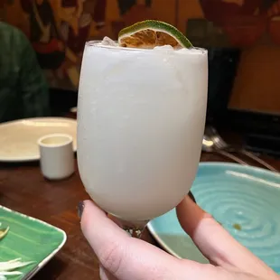 a person holding a glass of a drink