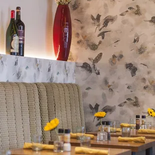 a long table with a vase of sunflowers