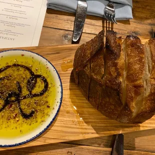 a piece of meat and a bowl of olive oil