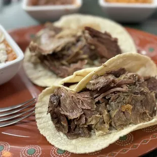 Barbacoa tacos were delicious, came with beans and rice. They also come with toppings and two different salsas.