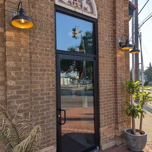 a brick building with a glass door
