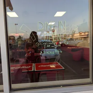 the reflection of a diner in the window
