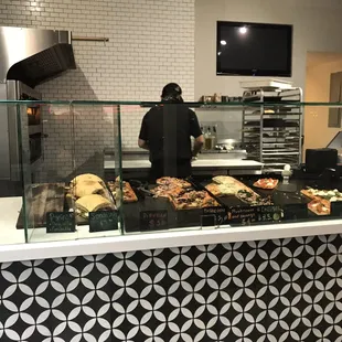 a man working behind a counter in a restaurant