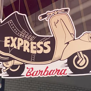 a scooter sign in front of a building