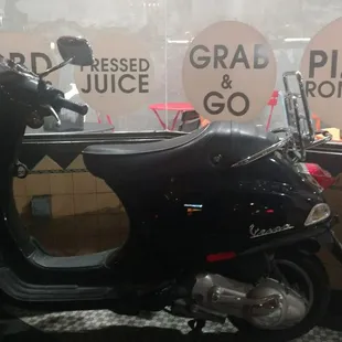 Outside, with their Vespa, adding an Italian flair.