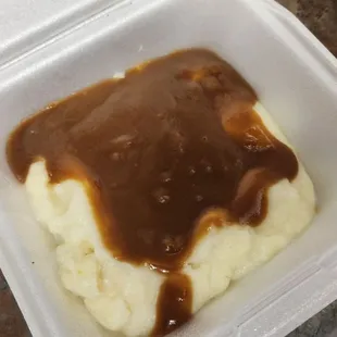a container of mashed potatoes and gravy