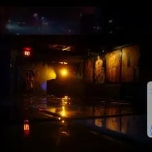 a dimly lit bar with a dark background