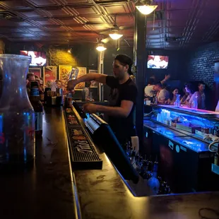 a bartender preparing a drink at a bar