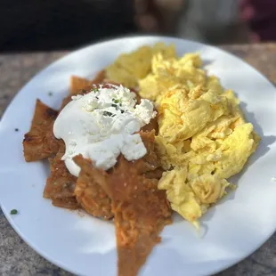 Chilaquiles en Salsa Roja . Soggy chips , unseasoned bland eggs. But it was a shame because the salsa was tasty .