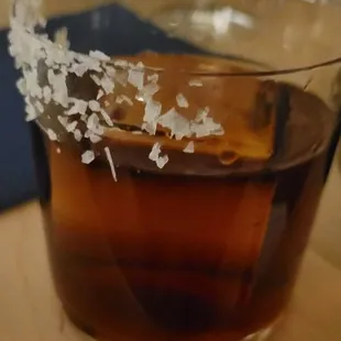 a glass of alcohol on a table