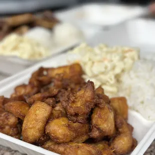 two takeout containers of food on a table