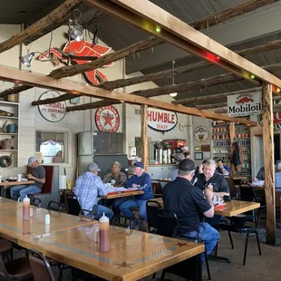 people sitting at tables in a restaurant
