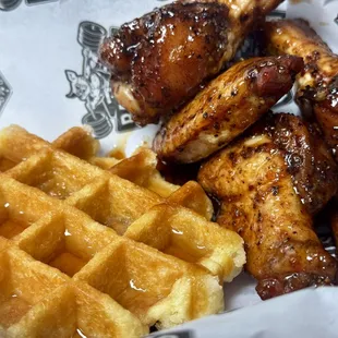 Wings and waffles. Wings are tossed in our raspberry chipotle sauce with a warm Belgian waffle.