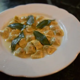 a plate of ravierole with sage leaves