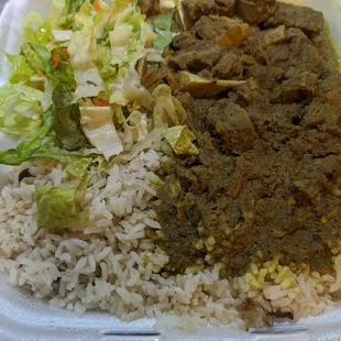 Curried goar with pigeon peas and rice and salad