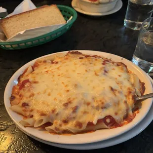 Penne with meat sauce and extra mozzarella, across the table is lasagna