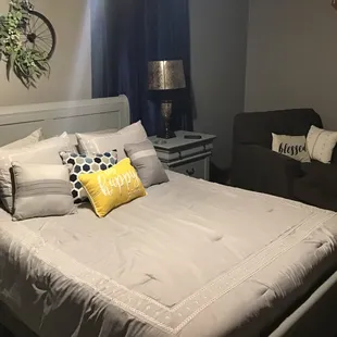 a bedroom with a bed and a chair