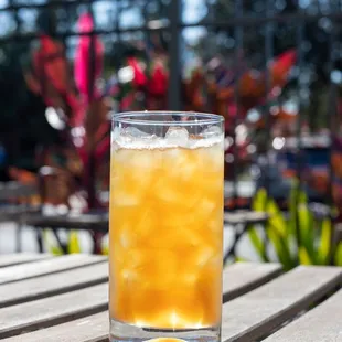 a glass of iced tea on a wooden table