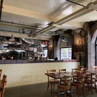 a view of a restaurant with a brick wall