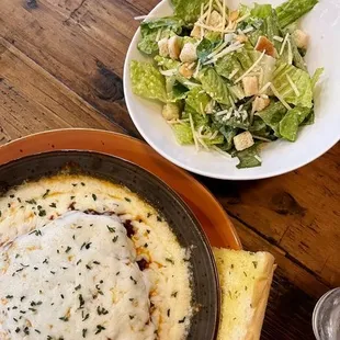 A snapshot of pure delight with their savory beef lasagna and a side of refreshing Caesar salad. Every bite, a masterpiece!