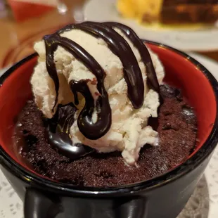 a chocolate cake with ice cream and chocolate sauce