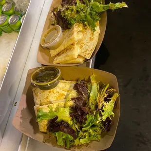 two burritos with lettuce and salsa