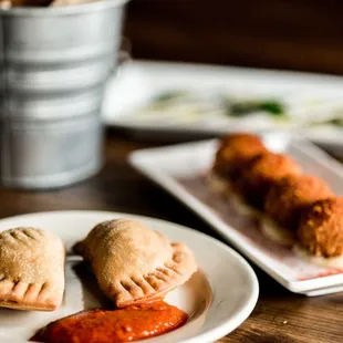 a plate of empanadas and a cup of coffee