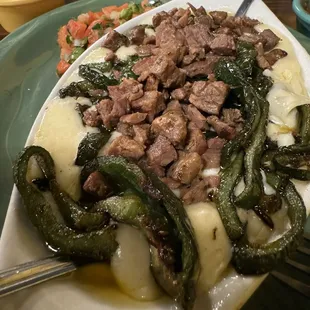 Queso Flameado with Roasted Poblanos, Fajita Beef, fresh pico; and hot tortilla.